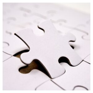 puzzle piece fitting into a puzzle